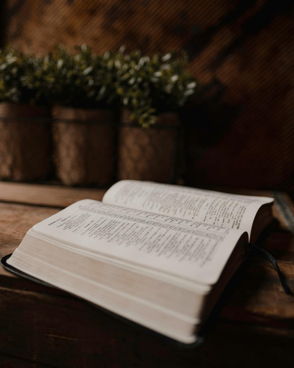 An open Bible on a wooden table